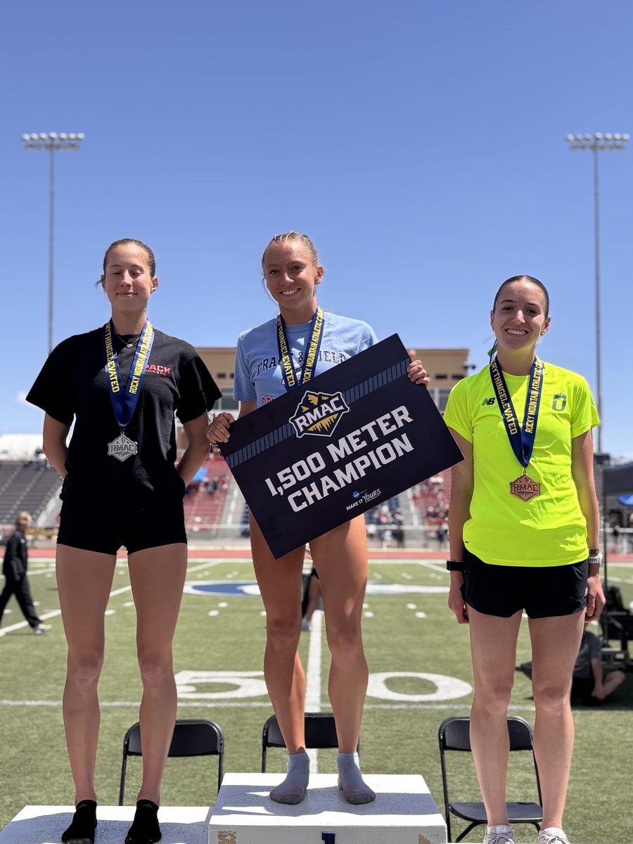 Helen Braybrook holding the RMAC 1,500m champion board